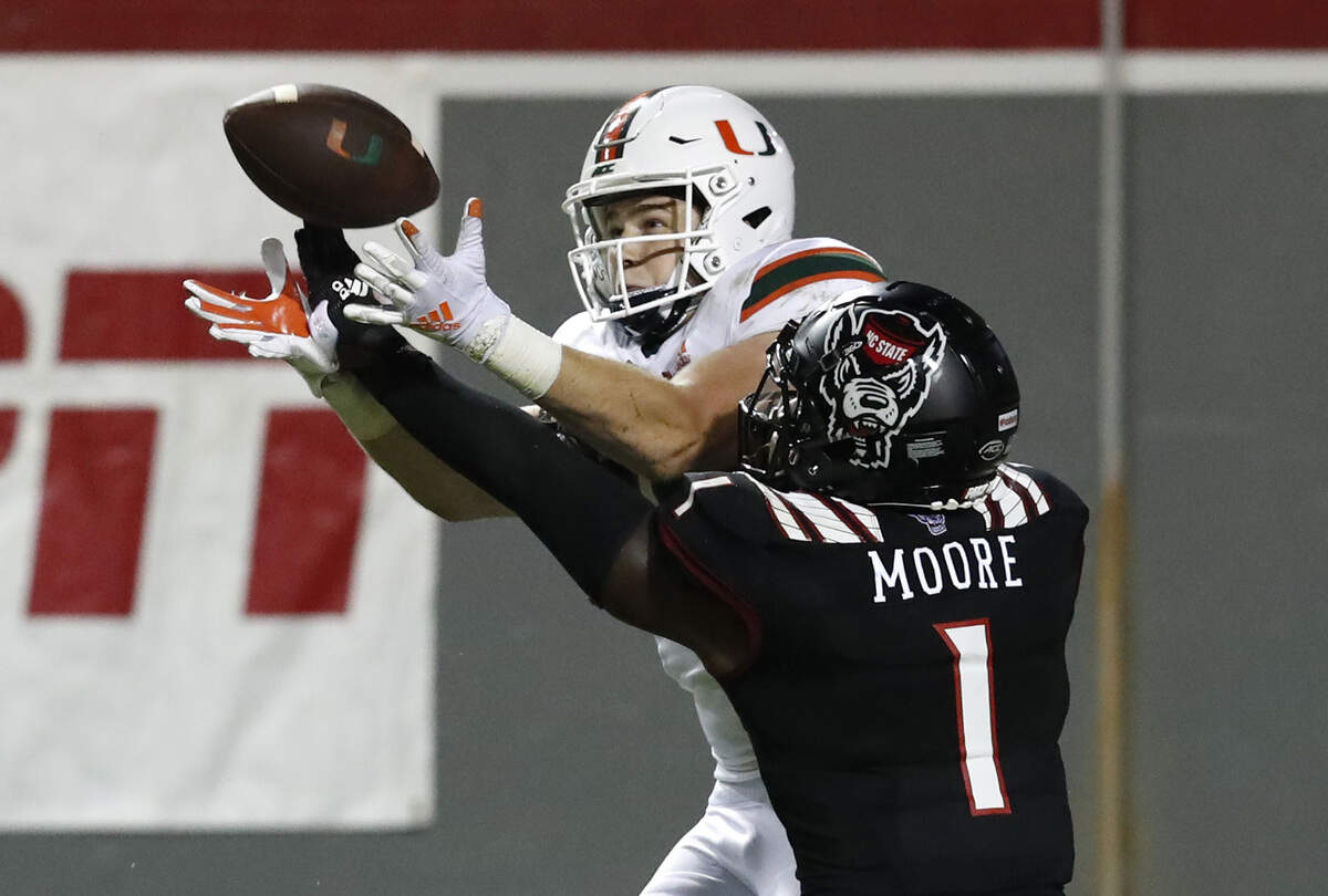 N.C. State linebacker Isaiah Moore (1) breaks up a pass intended for Miami tight end Will Mallory (85) during the second half of Miami’s 44-41 victory over N.C. State at Carter-Finley Stadium in Raleigh, N.C., Friday, Nov. 6, 2020.