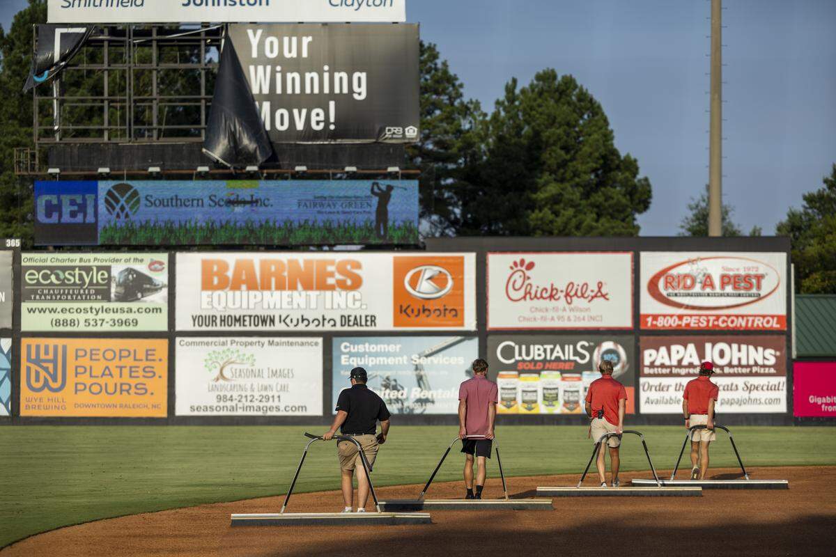 The Carolina Mudcats grounds crew rakes the infield during a recent game against the Kannapolis Cannon Ballers on Tuesday, July 22, 2025, at Five County Stadium in Zebulon, N.C. The Mudcats will conclude their 35th and final season in Zebulon.