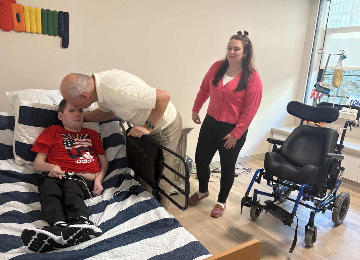 After a three-year wait, Doug Watson (center) moved his son, Tommy, into TLC’s new intermediate care facility for people with intellectual and developmental disabilities (IDD) in Raleigh. Also pictured is Tommy’s younger sister, Abigail.