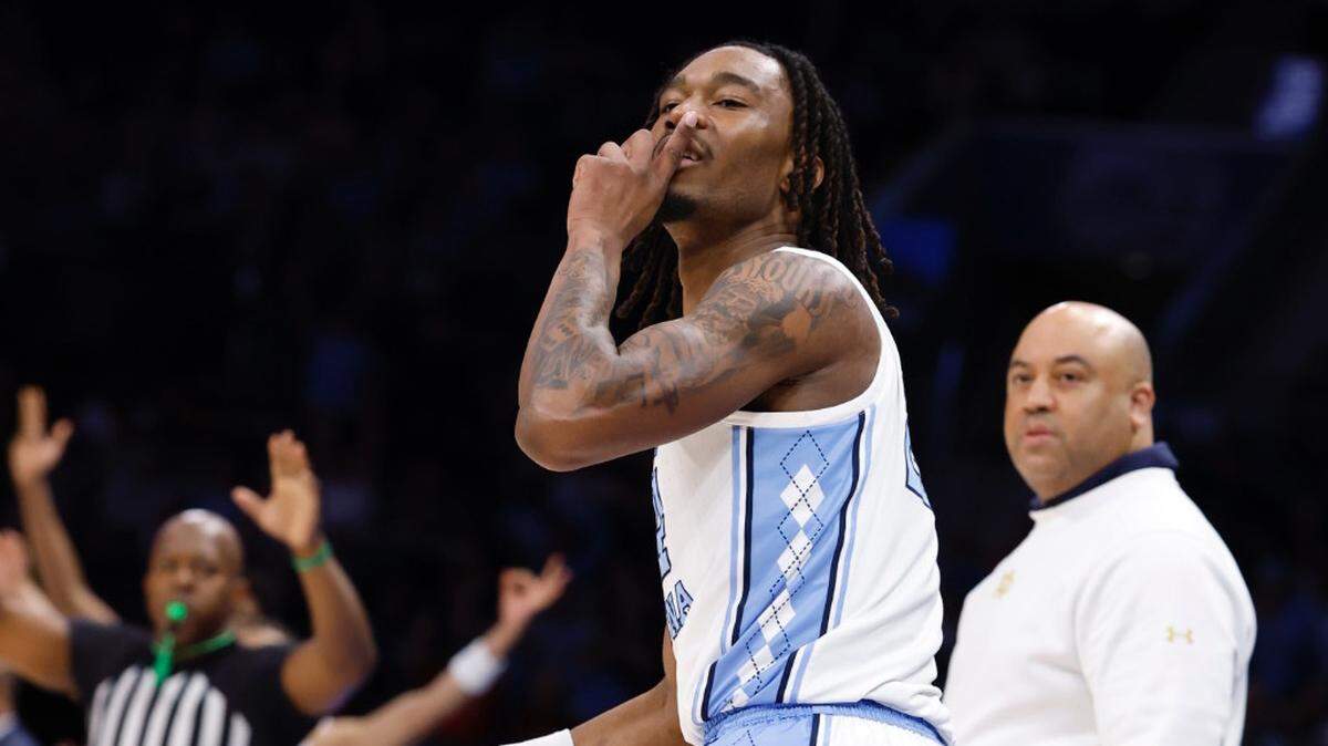 UNC’s Jae’Lyn Withers reacts after hitting a 3-pointer in action against Notre Dame in the ACC Tournament as Irish coach Micah Shrewsberry looks on.