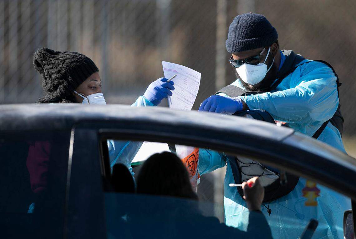 Joyvita Parker and Marqueith Parker collect a COVID-19 test sample from Sally Aguilar at the Greene County Senior Center on Thursday, December 3, 2020 in Snow Hill, N.C.