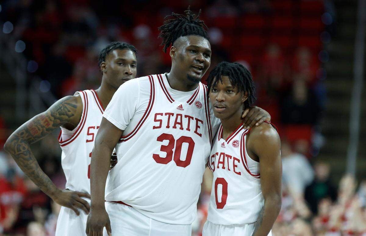 N.C. State’s D.J. Burns Jr. (30) talks with Terquavion Smith (0) during the second half of Clemson’s 96-71 victory over N.C. State’s game at PNC Arena in Raleigh, N.C., Saturday, Feb. 25, 2023.