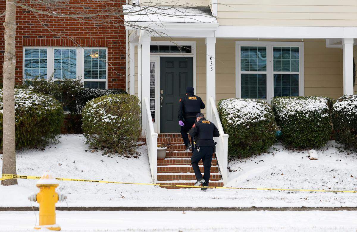 Police head to the door of 633 Democracy Street in Raleigh, N.C., on Wednesday morning, Jan. 22, 2025.