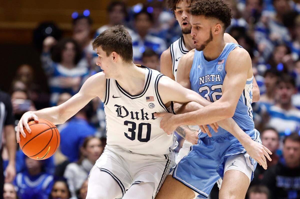 North Carolina’s Pete Nance (32) tries to slow down Duke’s Kyle Filipowski (30) during the first half of Duke’s game against UNC at Cameron Indoor Stadium in Durham, N.C., Saturday, Feb. 4, 2023.