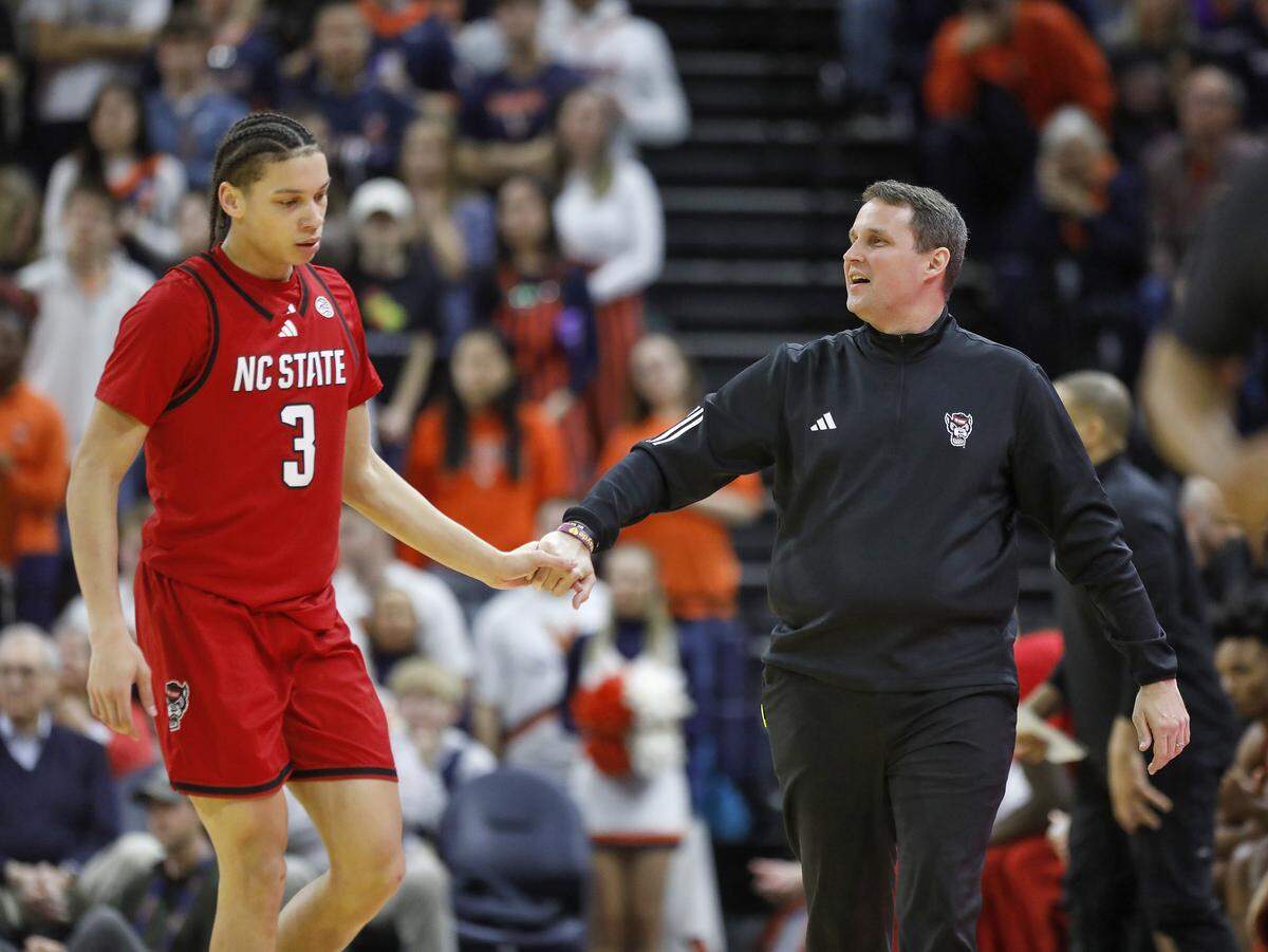 N.C. State head coach Will Wade speaks with Matt Able during the first half of the Wolfpack’s 90-61 loss to Virginia on Thursday, Feb. 24, 2026, at John Paul Jones Arena in Charlottesville, Va. 
