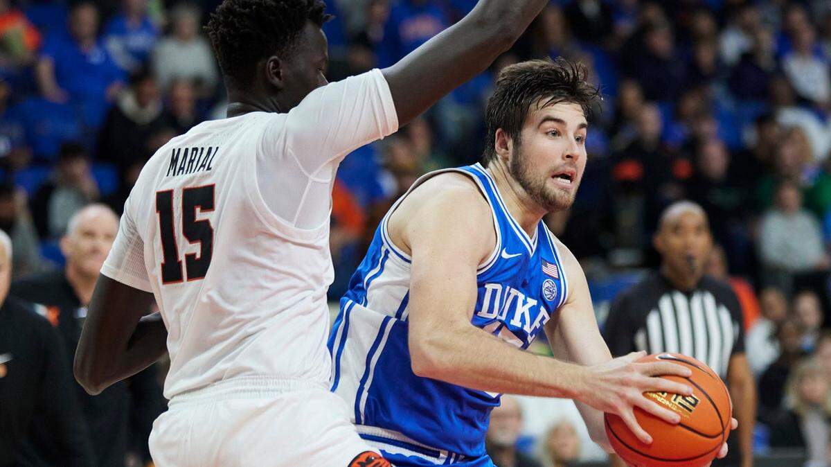 Duke center Ryan Young, right, drives to the basket against Oregon State center Chol Marial, left, during the first half of an NCAA college basketball game in the Phil Knight Legacy Tournament in Portland, Ore., Thursday, Nov. 24, 2022. (AP Photo/Craig Mitchelldyer)