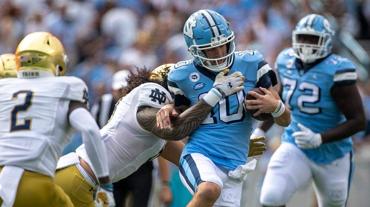 Notre Dame’s Marist Liufau (8) stops North Carolina quarterback Drake Maye (10) after a 15-yard again in the first quarter on Saturday, September 24, 2022 at Kenan Stadium in Chapel Hill, N.C.