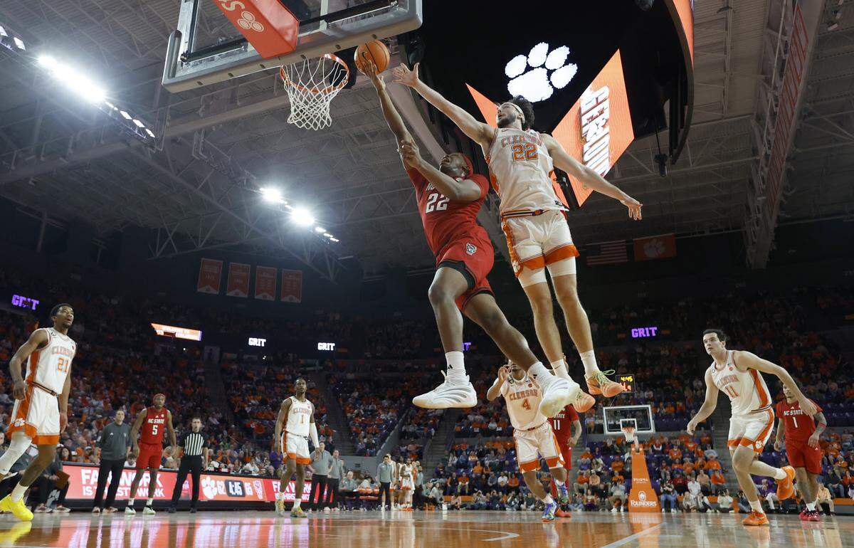 N.C. State's Ven-Allen Lubin (22) drives to the basket as Clemson's Carter Welling (22) defends during N.C. State’s 80-76 overtime victory over Clemson at Littlejohn Coliseum in Clemson, S.C., Tuesday, Jan. 20, 2026.
