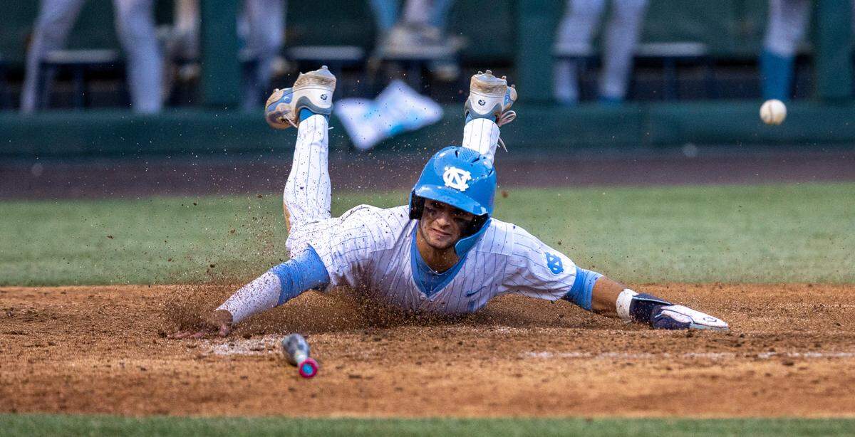 North Carolina’s Gavin Gallaher (5) slides safely into home ahead of the throw to Long Island University catcher Luke Stevenson on a 2 RBI single by Alex Madera in the sixth inning to take a 5-3 lead during the NCAA Regional on Friday, May 31, 2024 at Boshamer Stadium in Chapel Hill, N.C.
