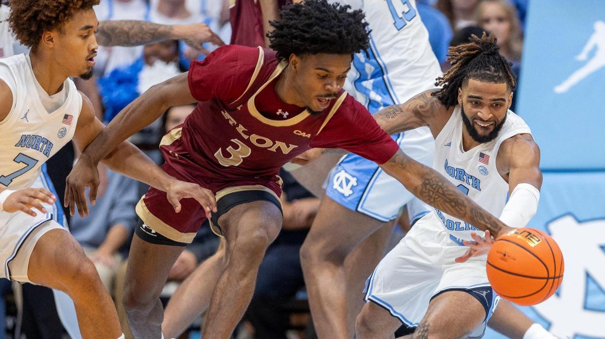 North Carolina guard R.J. Davis (4) works for a steal from Elon’s T.K. Simpkin’s (3) during the first half on Monday, November 4, 2024 at the Smith Center in Chapel Hill, N.C.
