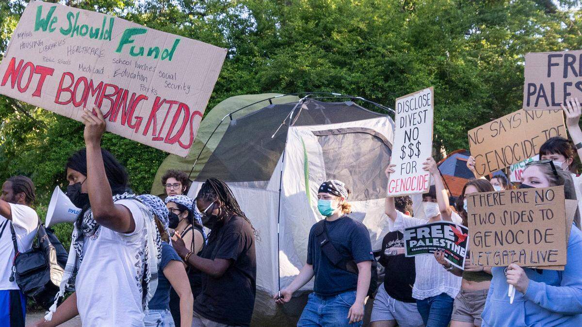 Demonstrators march outside an event attended by former UNC-Chapel Chancellor Kevin Guskiewicz during a pro-Palestinian protest and encampment at UNC Chapel Hill on Monday, April 29, 2024.