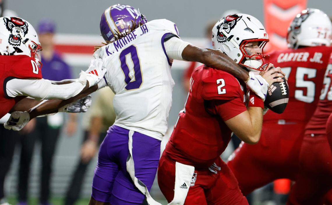 N.C. State quarterback Grayson McCall (2) scrambles past Western Carolina cornerback Ken Moore Jr. (0) during the second half of N.C. State’s 38-21 victory over Western Carolina at Carter-Finley Stadium in Raleigh, N.C., Thursday, August 29, 2024.