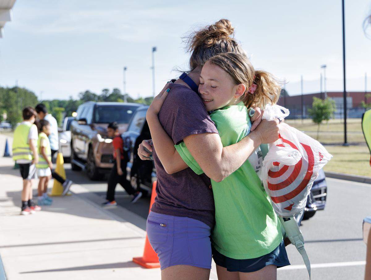 Amy Skorich hugs her daughter, fifth-grader Elle Skorich, as students arrive to Apex Friendship Elementary School on Tuesday, May 5, 2026.