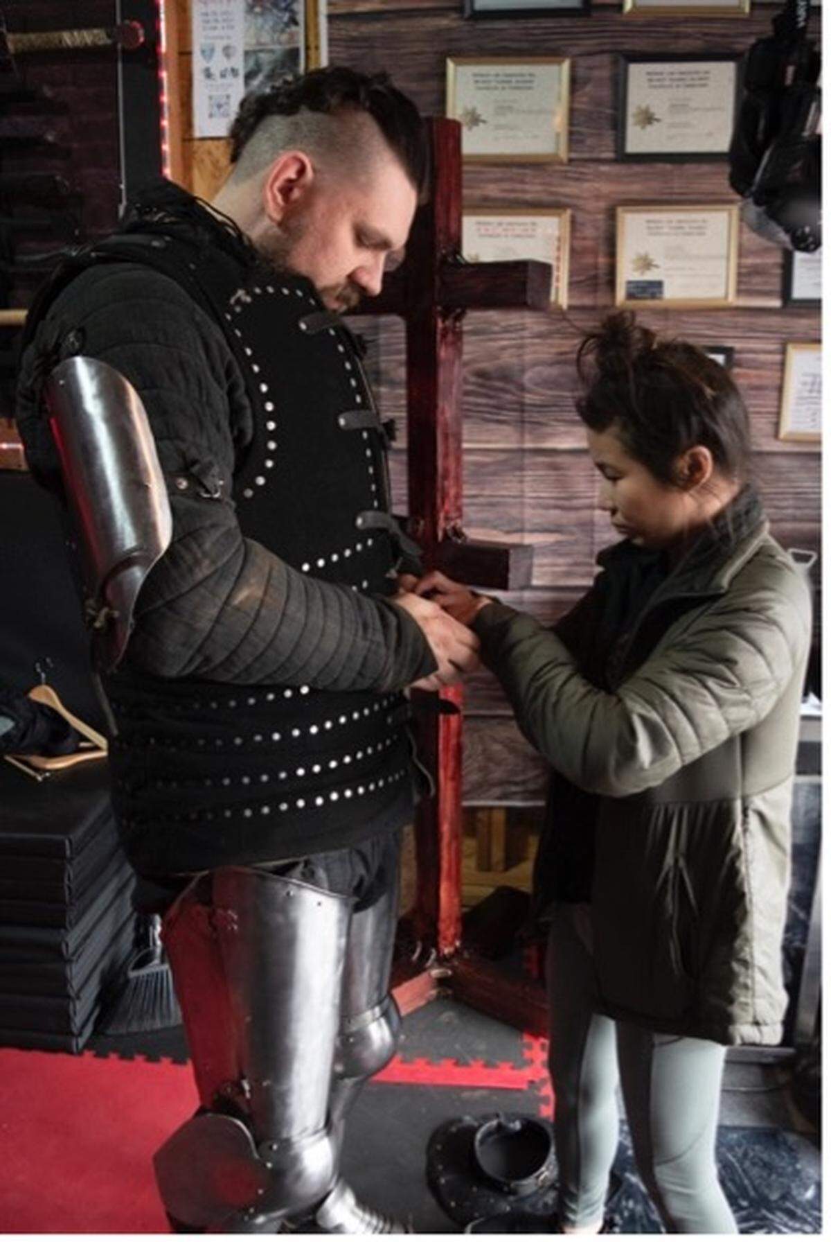 Jarred Bender and his wife, Carrie Bender, help him get into his armor, known as his kit. Jarred Bender is part of the NC Dire Drakes, a medieval combat fighting team. Members wear 80 pounds of steel armor and use shields and dulled axes and swords. They compete in an up-and-coming worldwide sport that combines extreme athleticism and the history of 14th- and 16th-century combat styles.