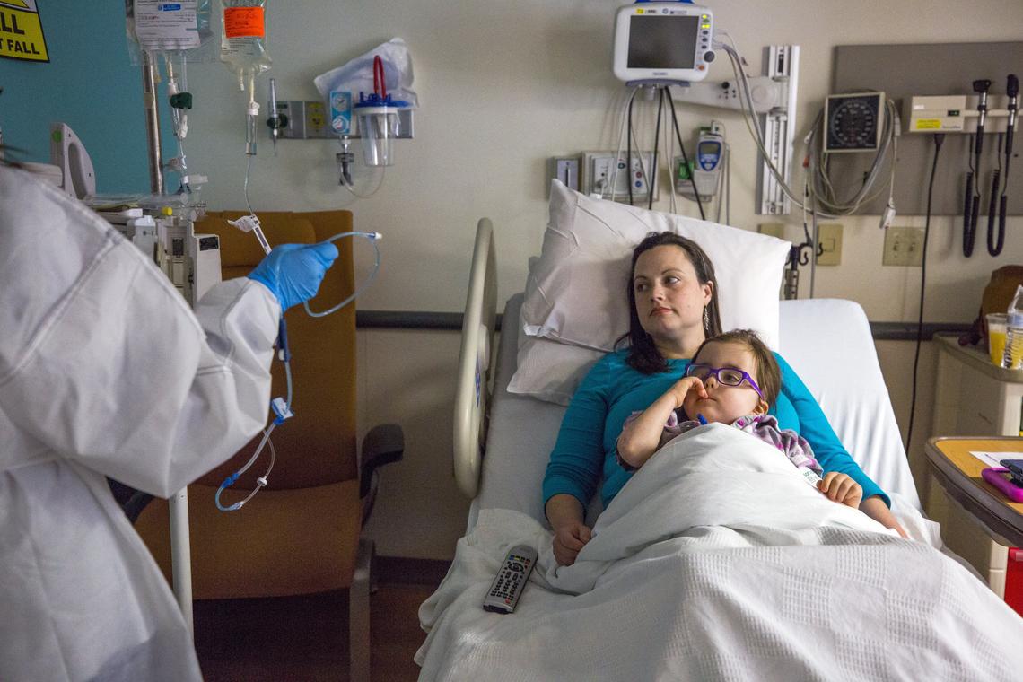 Emily Neill, 31, settles in with her daughter, Avery, at Duke Hospital.