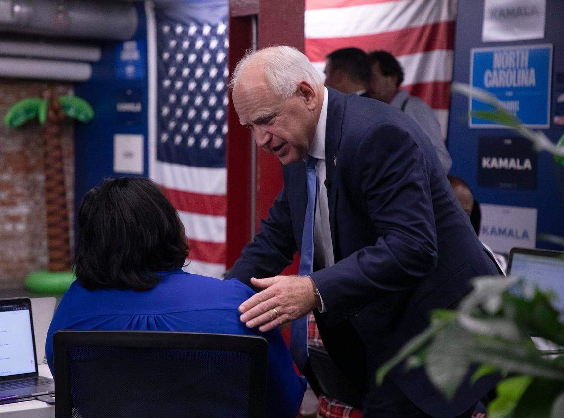 Democratic Vice Presidential nominee and Minnesota Gov. Tim Walz speaks with a volunteer during a visit to a campaign office in Raleigh, N.C. on Thursday, Aug. 29, 2024.