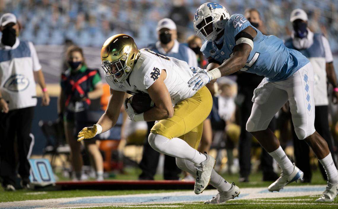 Notre Dame’s George Takacs (85) gets past North Carolina’s Tyrone Hopper (42) picking up 13 yards on a pass completion from quarterback Ian Book (12) to set up Notre Dame’s final score late in the fourth quarter, and secure their 31-17 victory over North Carolina.