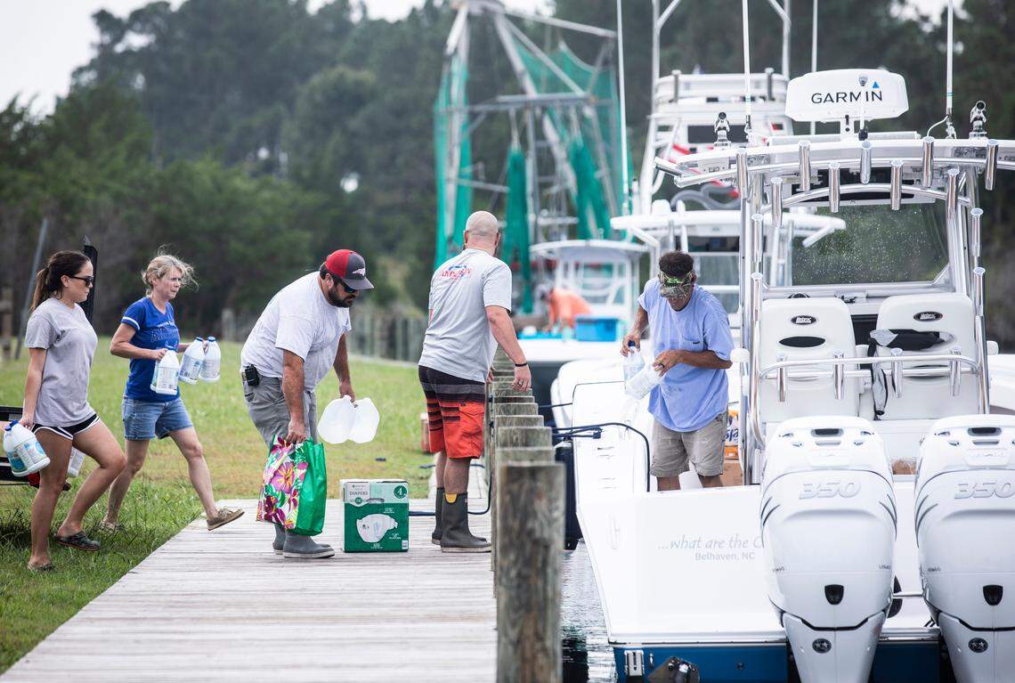 Volunteers from nearby communities load supplies onto boats headed to Ocracoke from the N.C. Wildlife Resources boat ramp in Swan Quarter on Sunday, Sept. 8, 2019.
