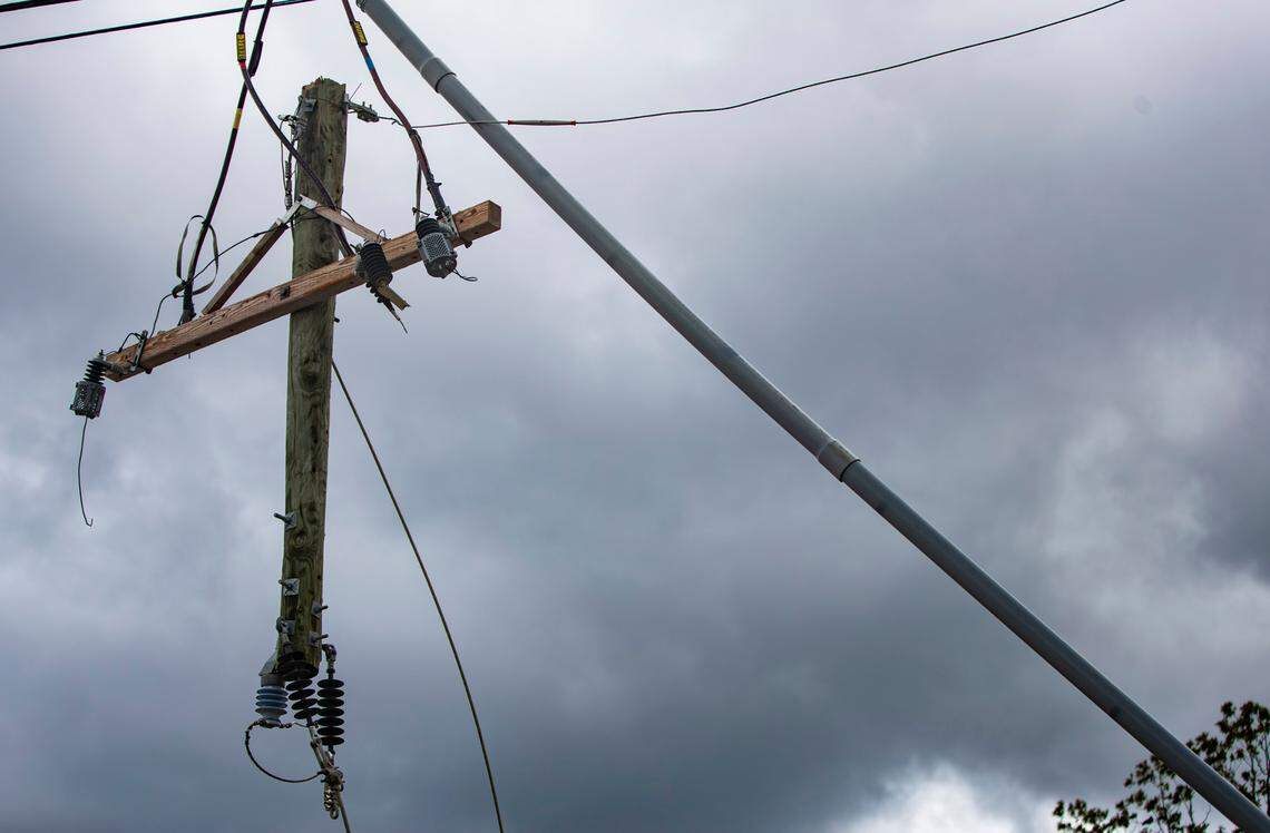 Remnants of a light pole hang above Overlook Road in Arden Friday afternoon after Hurricane Helene passed through the Asheville area the night before.