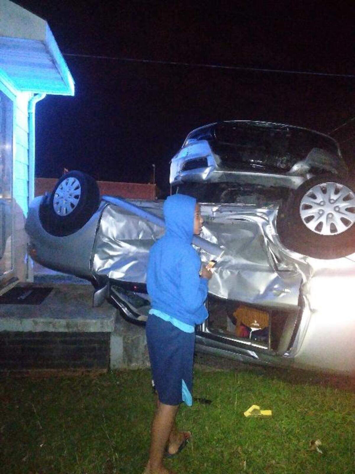 Issaia Russell, 9, views the scene of a wrecked State Highway Patrol cruiser in Burlington, N.C., on May 28, 2022.