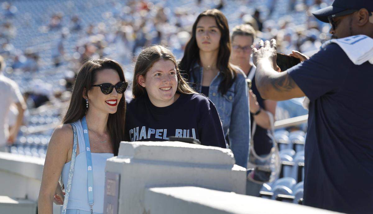 A fan has her photo taken with Jordon Hudson before UNC’s game against Clemson at Kenan Stadium in Chapel Hill, N.C., Sat. Oct. 4, 2025.