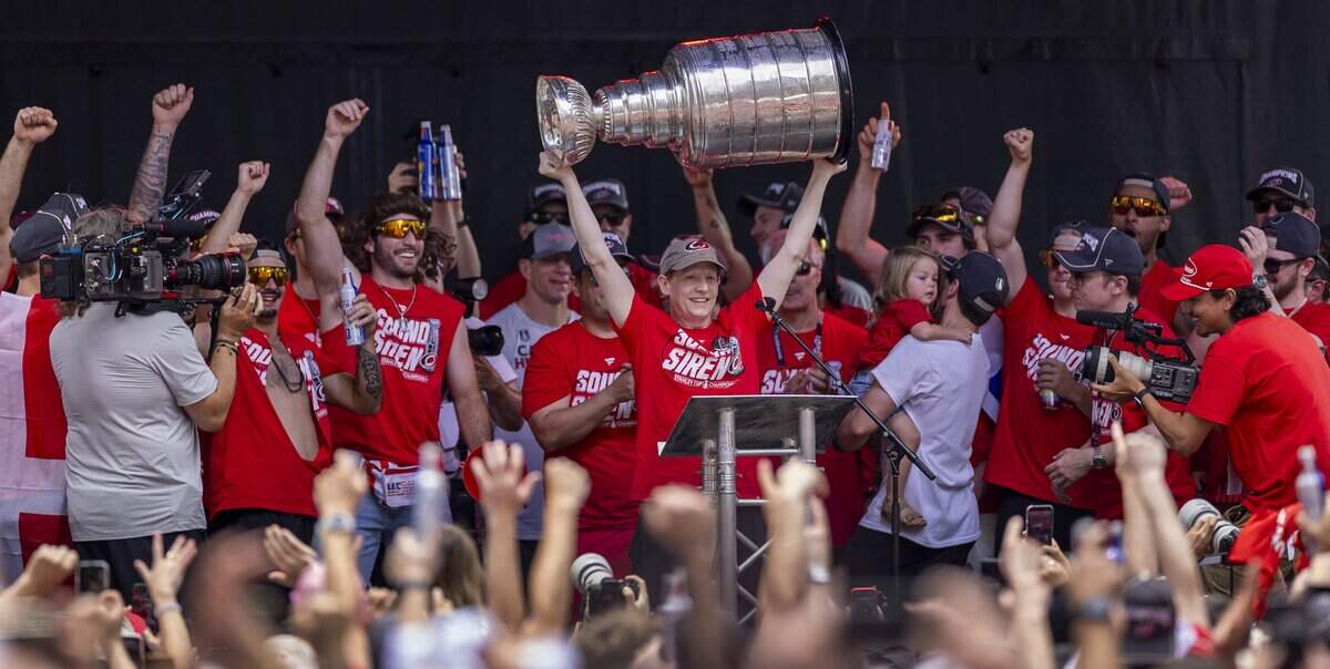 Carolina Hurricanes general manager Eric Tulsky hoists the Stanley Cup during the rally on the City Plaza on Saturday, June 20, 2026 in Raleigh, NC.