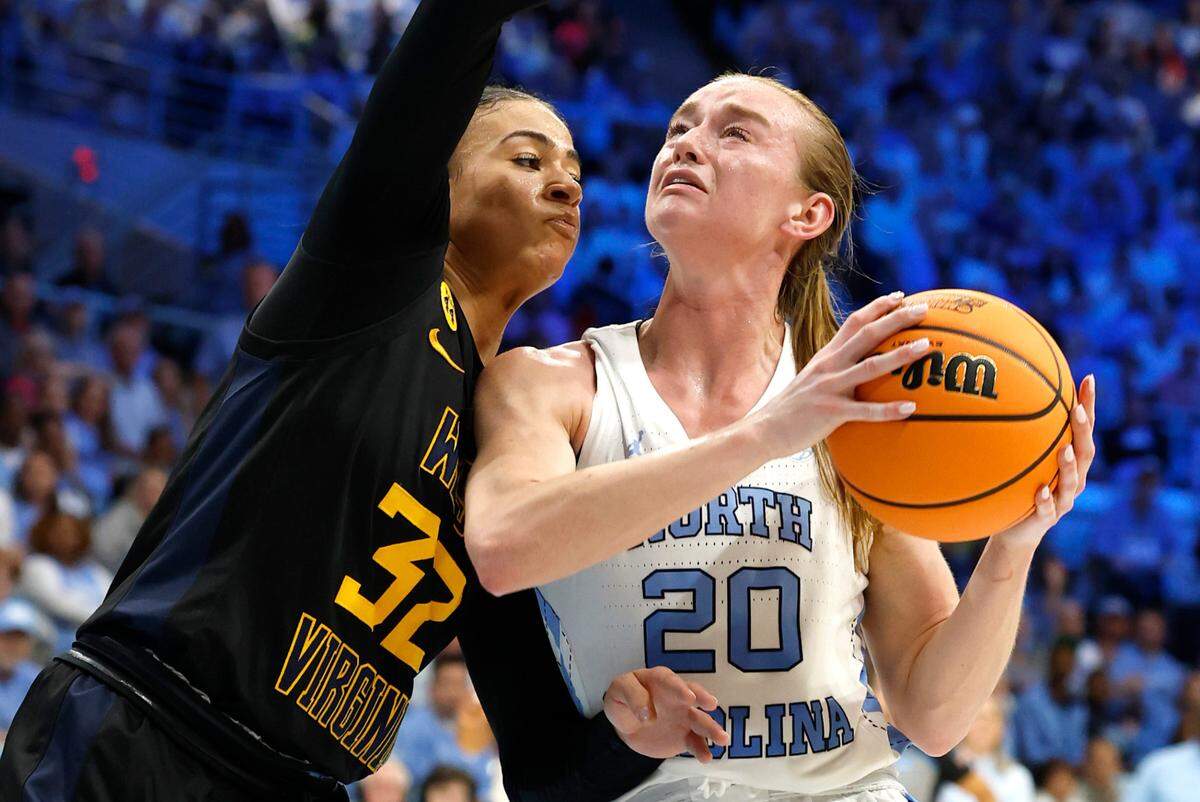 North Carolina’s Lexi Donarski (20) prepares to shoot as West Virginia’s Kyah Watson (32) defends during the first half of UNC’s game against West Virginia in the second round of the NCAA women’s basketball tournament at Carmichael Arena in Chapel Hill, N.C., Monday, March 24, 2025.