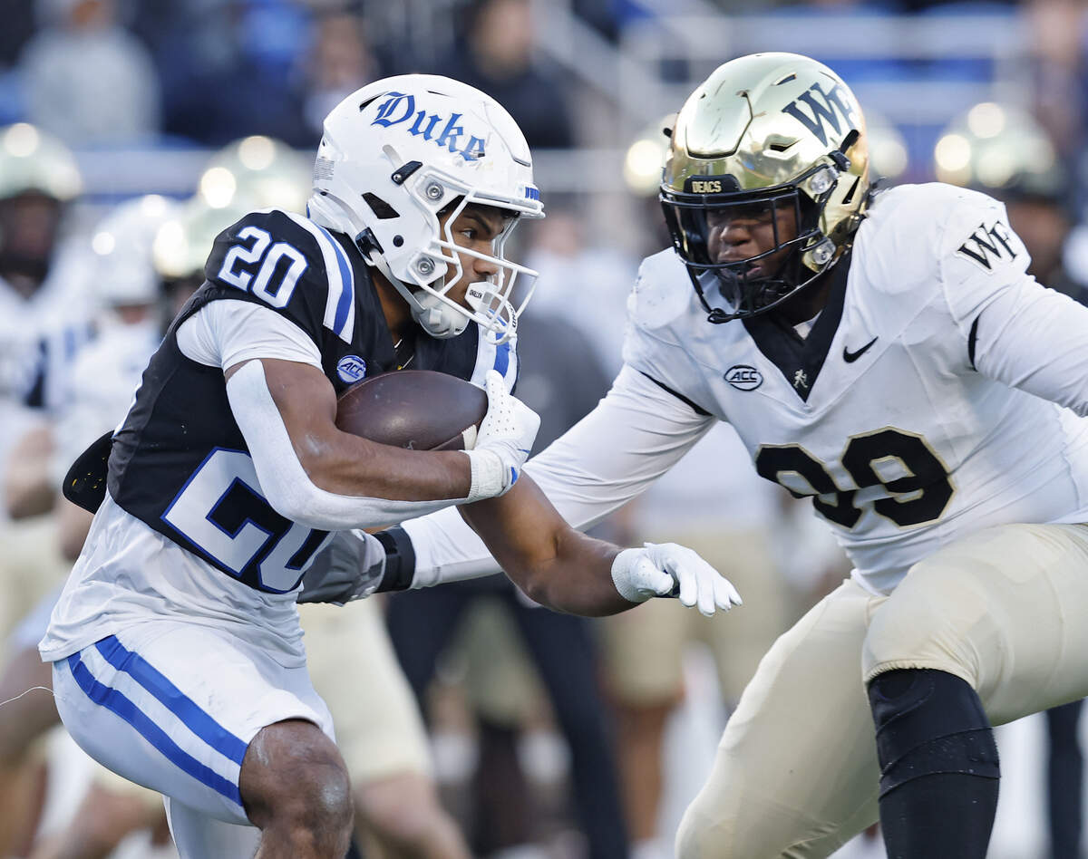 Duke’s Nate Sheppard runs the ball past Wake Forest’s Mateen Ibirogba during the first half of the Blue Devils’ 49-32 win on Saturday, Nov. 29, 2025, at Wallace Wade Stadium in Durham, N.C.