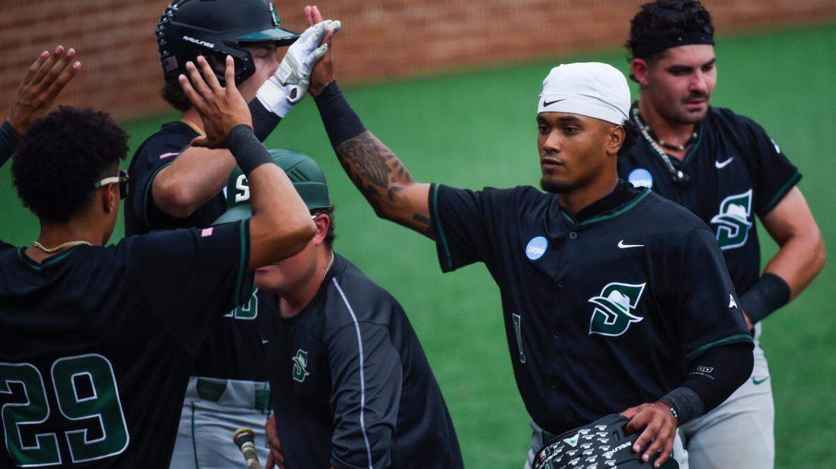 Stetson Hatters’ Juan De La Cruz (0) celebrates scoring against the NC State Wolfpack during the NCAA Baseball Regional Tournament at Plainsman Park in Auburn, Ala., on Friday May 30, 2025.