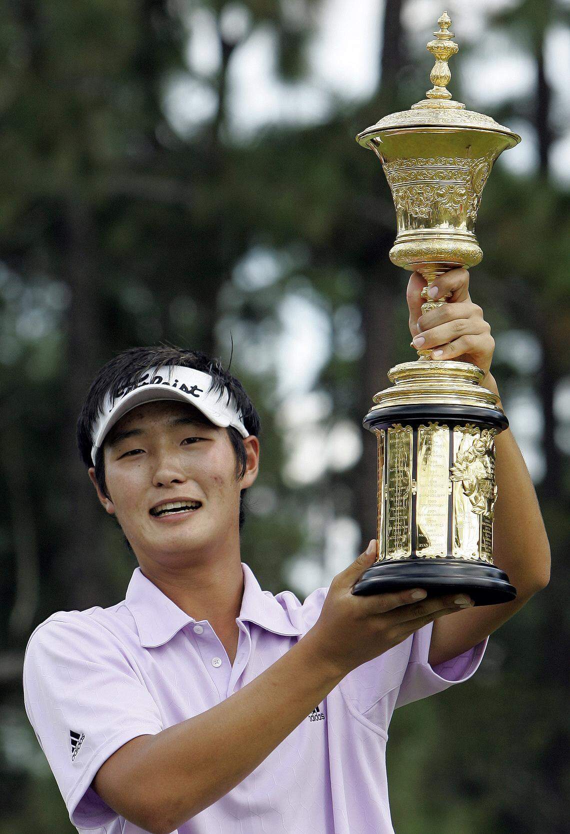 Danny Lee, of New Zealand, holds the trophy on the 14th green after winning the U.S. Amateur golf tournament in Pinehurst, N.C., Sunday, Aug. 24, 2008. Lee defeated Drew Kittleson 5 and 4 in match play to win the tournament. (AP Photo/Gerry Broome)