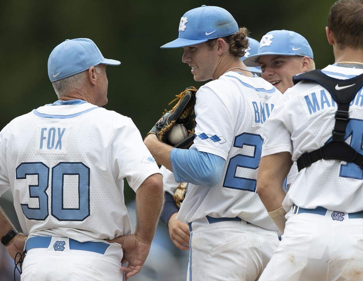 North Carolina coach Mike Fox talks with starting pitcher Tyler Baum before removing him from the mound after just over six innings against Auburn during the NCAA Super Regional on Saturday, June 8, 2019 at Boshamer Stadium in Chapel Hill, N.C.