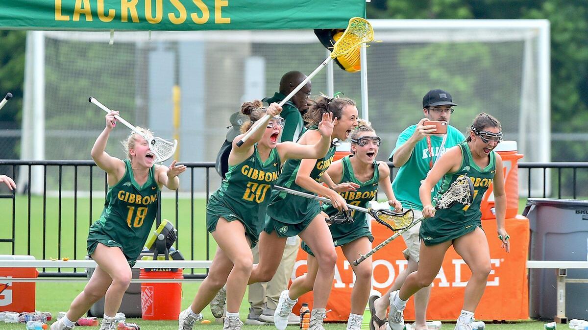 The Cardinal Gibbons Crusaders sprint onto the field after their victory over Charlotte Catholic in the Women’s Lacrosse Finals. The Cardinal Gibbons Crusaders and the Charlotte Catholic Cougars met in the NCHSAA Women’s Lacrosse Championships in Cary, N.C. on May 21, 2022.