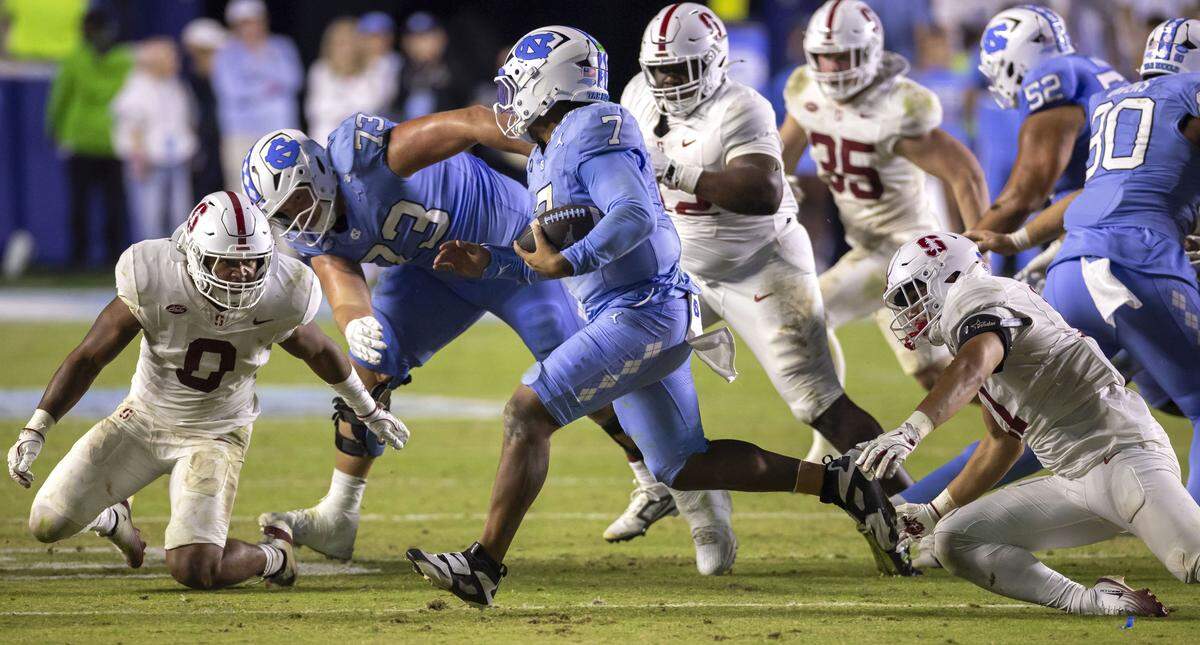 North Carolina quarterback Gio Lopez (7) looks for running room against the Stanford defense before being stopped for a four yard loss in the fourth quarter on Saturday, November 8, 2025 at Kenan Stadium in Chapel Hill, N.C.