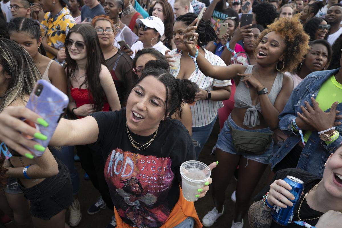 Andrea Millich of New York, NY records herself singing along to recording artist Teyana Taylor at the Shine Stage during her set on Saturday afternoon April 6, 2019 at the Dreamville Festival at Dix Park in Raleigh, N.C. The inaugural event, the brainchild of artist J. Cole, drew thousands of music fans to the day long event at Dix Park.