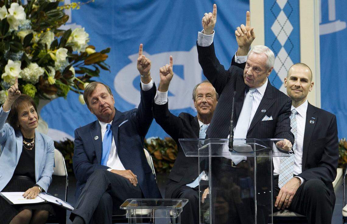 North Carolina coach Roy Williams asks those in attendance to point to the assist man a nod to Dean Smith’s insistence that his players acknowledge the teammate who had set up their chance to score, during a memorial service for Dean Smith on Sunday, February, 22, 2015 at the Smith Center in Chapel Hill, N.C. UNC chancellor Carol Folt, former player Mickey Bell, Erskine Bowles, and former player Eric Montross comply.