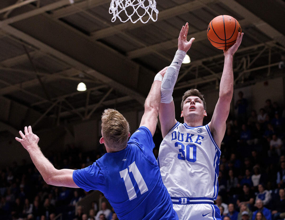 Duke’s Kyle Filipowski shoots over Hofstra’s Jacco Fritz during the first half of the Blue Devils’ game on Tuesday, Dec. 12, 2023, at Cameron Indoor Stadium in Durham, N.C.