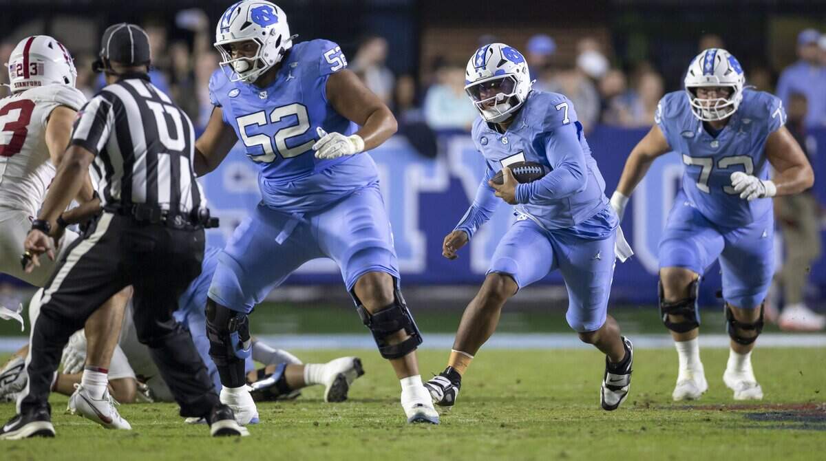 North Carolina quarterback Gio Lopez (7) looks for running room behind lineman Daniel King (52), picking up eight yards, in the second quarter against Stanford on Saturday, November 8, 2025 at Kenan Stadium in Chapel Hill, N.C.