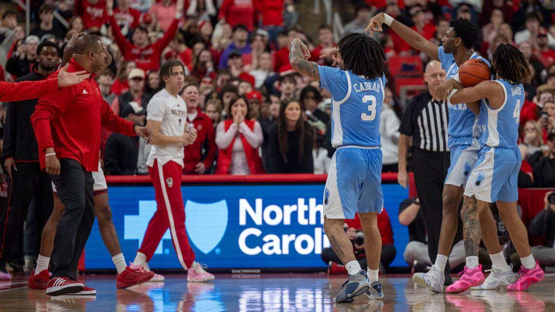 North Carolina guard Elliot Cadeau (3), forward Jalen Washington (13) and guard R.J. Davis (4) taunt the N.C. State bench, including Jordan Snell (22), following their 63-61 victory on Saturday, January 11, 2025 at Lenovo Center in Raleigh, N.C.