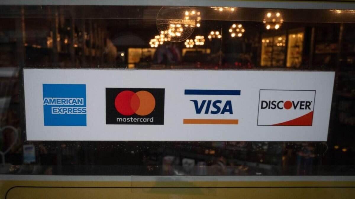 CHICAGO, ILLINOIS - FEBRUARY 11: A sticker shows that the American Express credit card is accepted at the front of a business on February 11, 2025 in Chicago, Illinois. (Photo by Scott Olson/Getty Images)