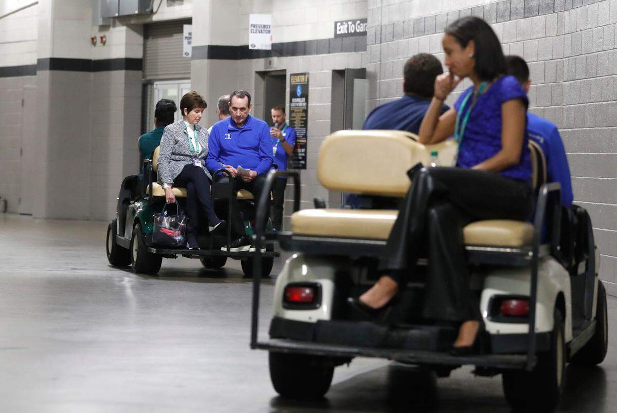 Duke head coach Mike Krzyzewski and wife Micke head back to the locker room after the post game press conference after North Carolina’s 81-77 victory over Duke in the Final Four at Caesars Superdome in New Orleans, La., Saturday, April 2, 2022. Duke athletic director Nina King is to the right.