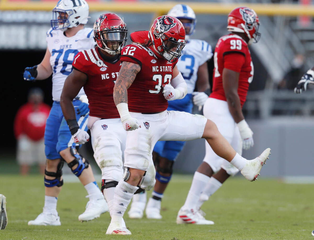 N.C. State linebacker Drake Thomas (32) celebrates after tackling Duke running back Mataeo Durant (21) for a loss during the first half of N.C. State’s game against Duke at Carter-Finley Stadium in Raleigh, N.C., Saturday, Oct. 17, 2020.