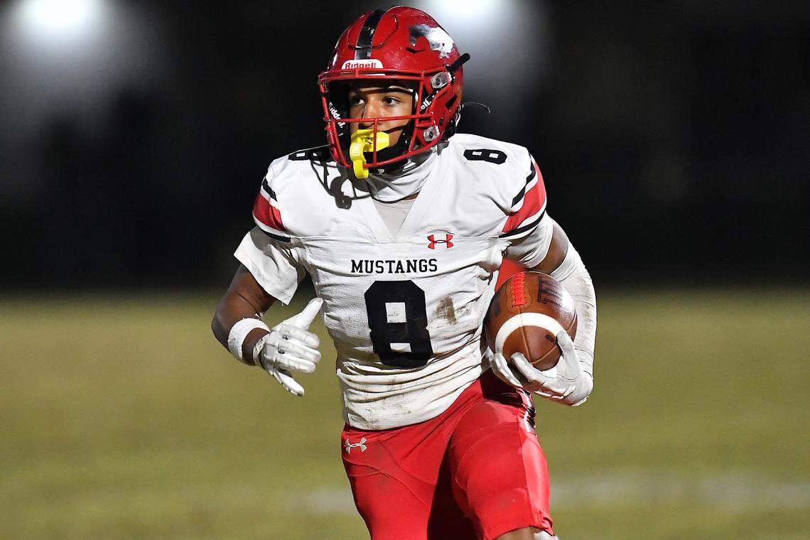 Middle Creek wide receiver Tracy Harrington Jr (8) rushes for yards against Cary during the first half. The Cary Imps and the Middle Creek Mustangs met in a conference football game in Cary, N.C. on October 24, 2025