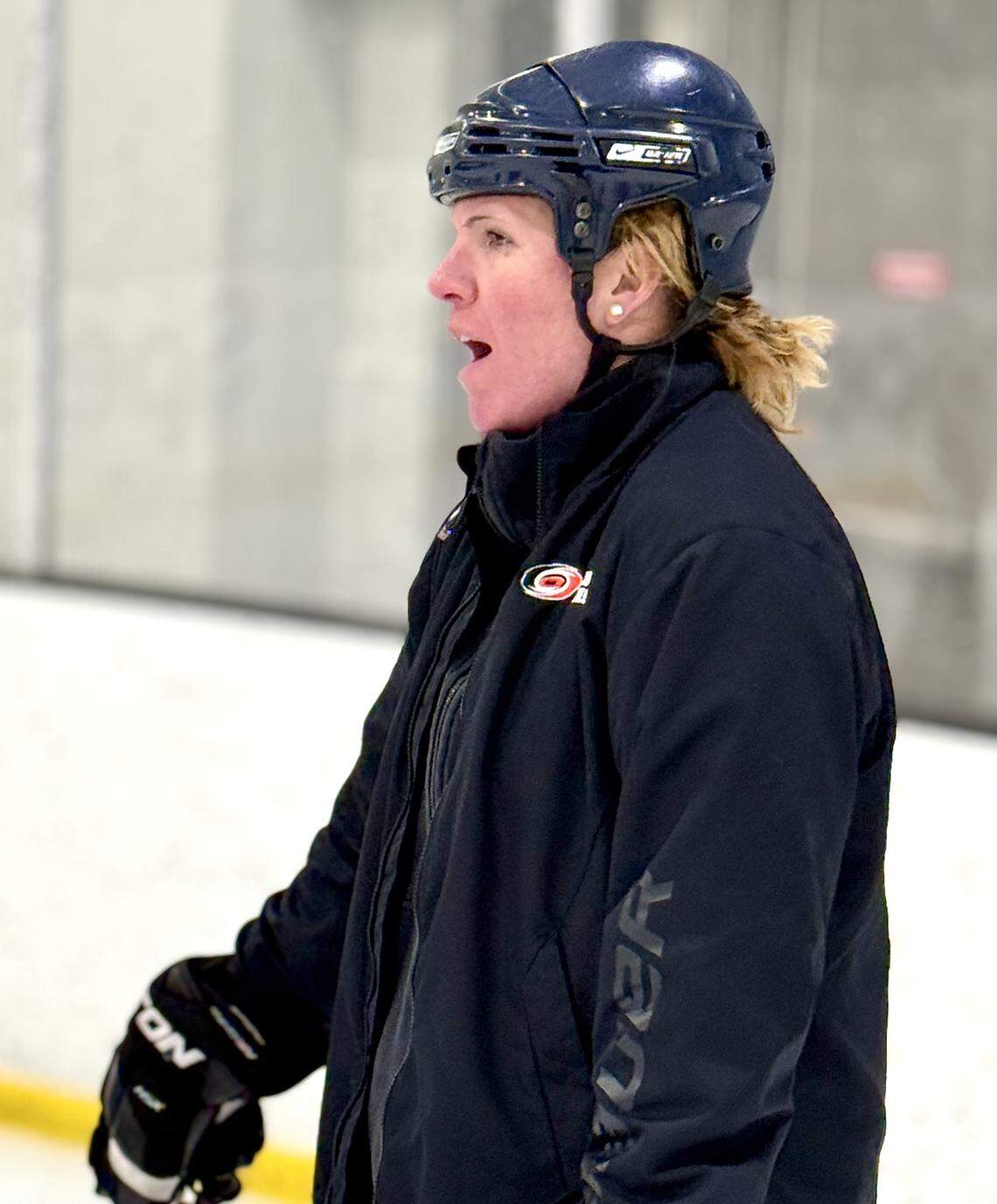 Hockey coach Jessica Hughes goes over drill instructions at a Junior Canes Girls U10 Red practice at Invisalign Arena at Wake Competition Center in Morrisville, N.C., on Thursday, Jan. 29, 2026.