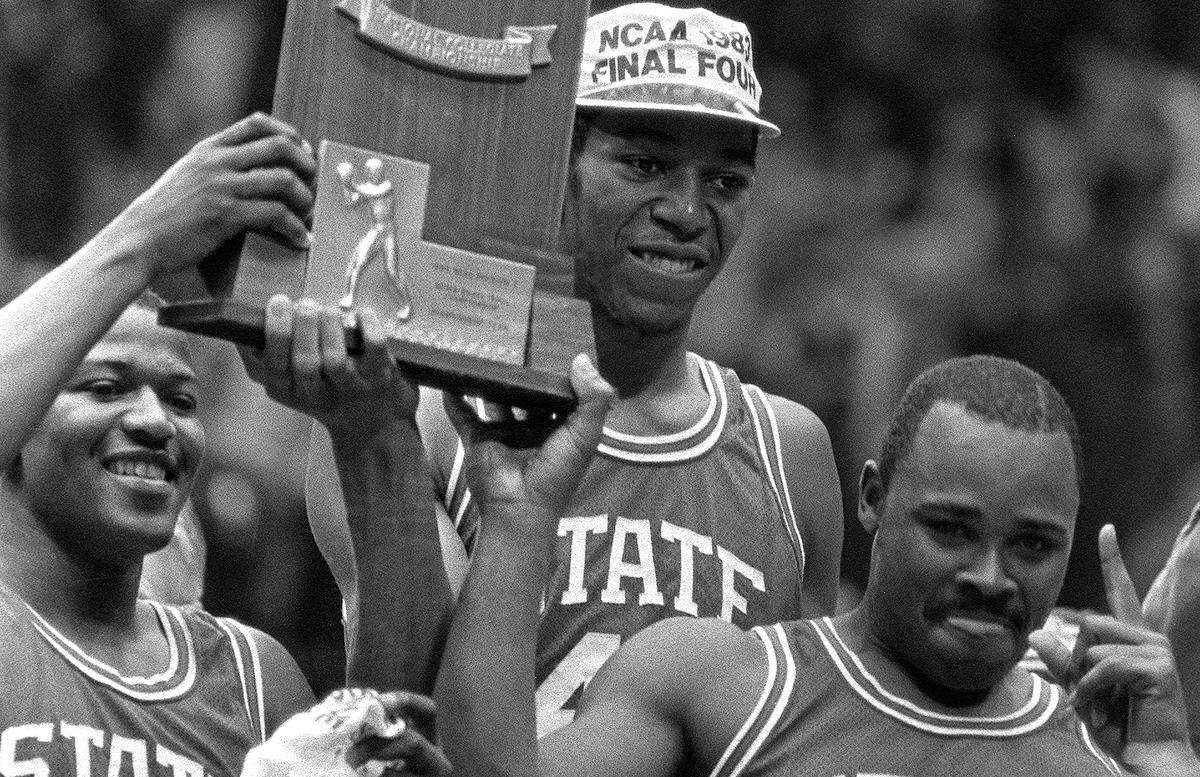 NC State’s Derrick Whittenburg, left, Thurl Bailey, and Sidney Lowe hoist the 1983 NCAA Championship trophy after the Wolfpack defeated Houston to win the National championship on April 5, 1983.