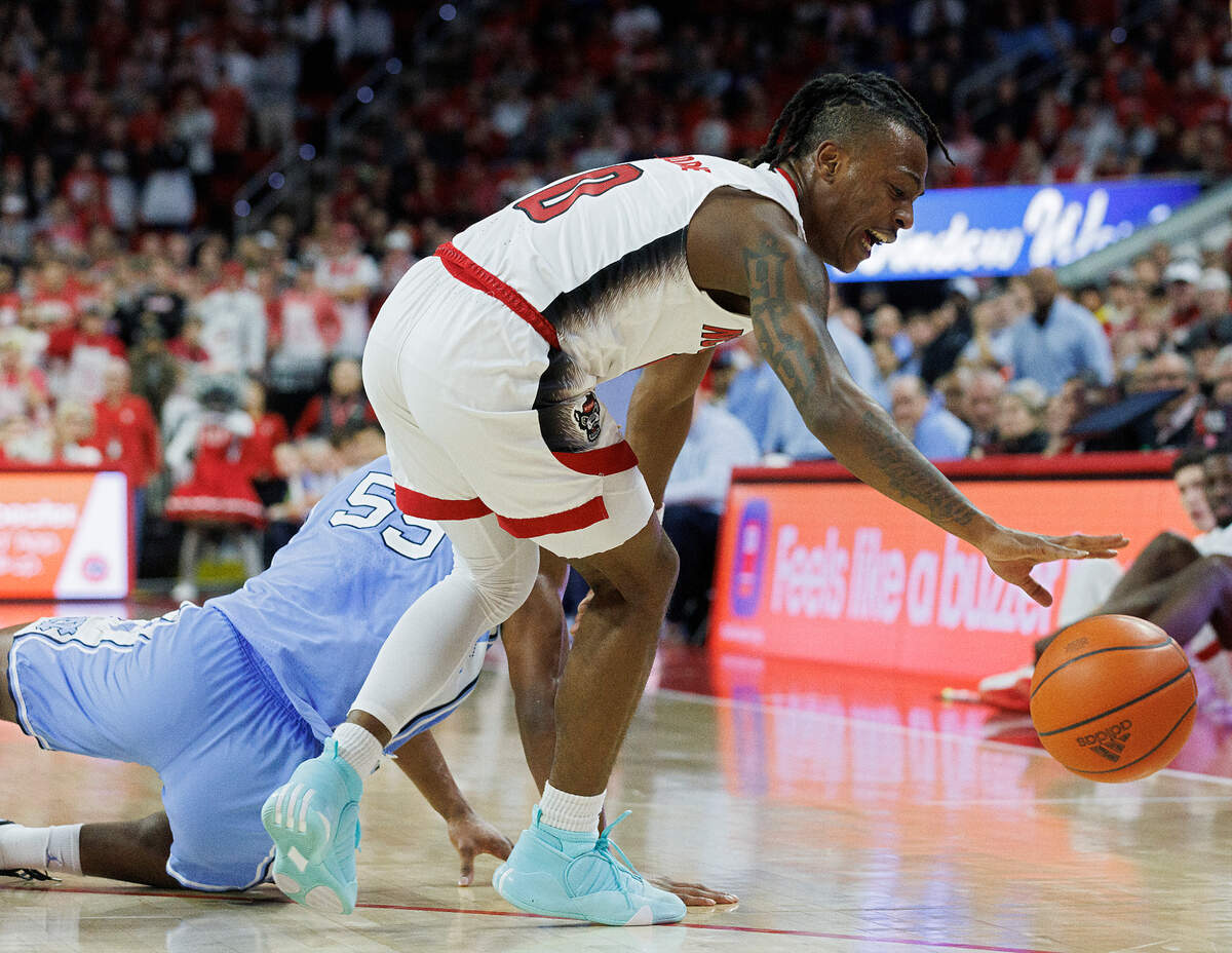 N.C. State’s DJ Horne handles the ball in front of North Carolina’s Harrison Ingram during the first half of the Wolfpack’s game at PNC Arena on Wednesday, Jan. 10, 2024, in Raleigh, N.C.