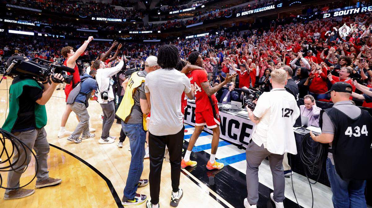 The Wolfpack celebrate with the crowd after N.C. State’s 67-58 victory over Marquette in their NCAA Tournament Sweet 16 game at the American Airlines Center in Dallas, Texas, Friday, March 29, 2024.