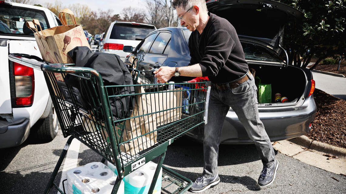 Are stores safe? Shoppers stock up, while businesses try to ease coronavirus fears.