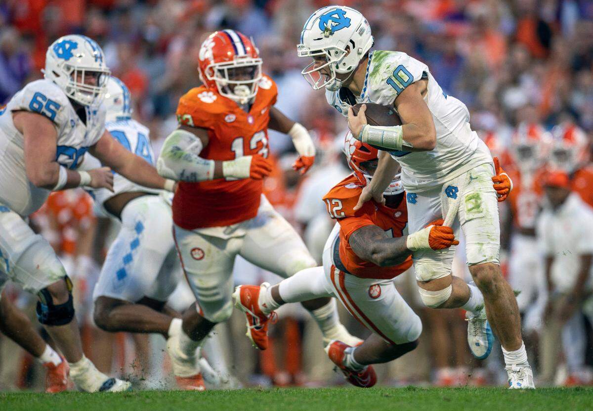Clemson’s T.J. Parker (12) sacks North Carolina quarterback Drake Maye (10) for an eight-yard loss in the second quarter on Saturday, November 18, 2023 at Memorial Stadium in Clemson, S.C.