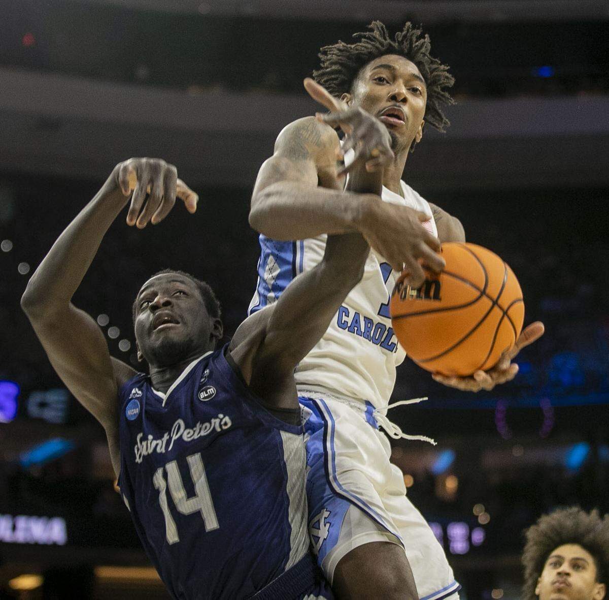 North Carolina’s Leaky Black (1) battles for a rebound with Saint Peter’s Hassen Drame (14) during the second half in the NCAA East Regional final on Sunday, March 27, 2022 at Wells Fargo Center in Philadelphia, Pa.