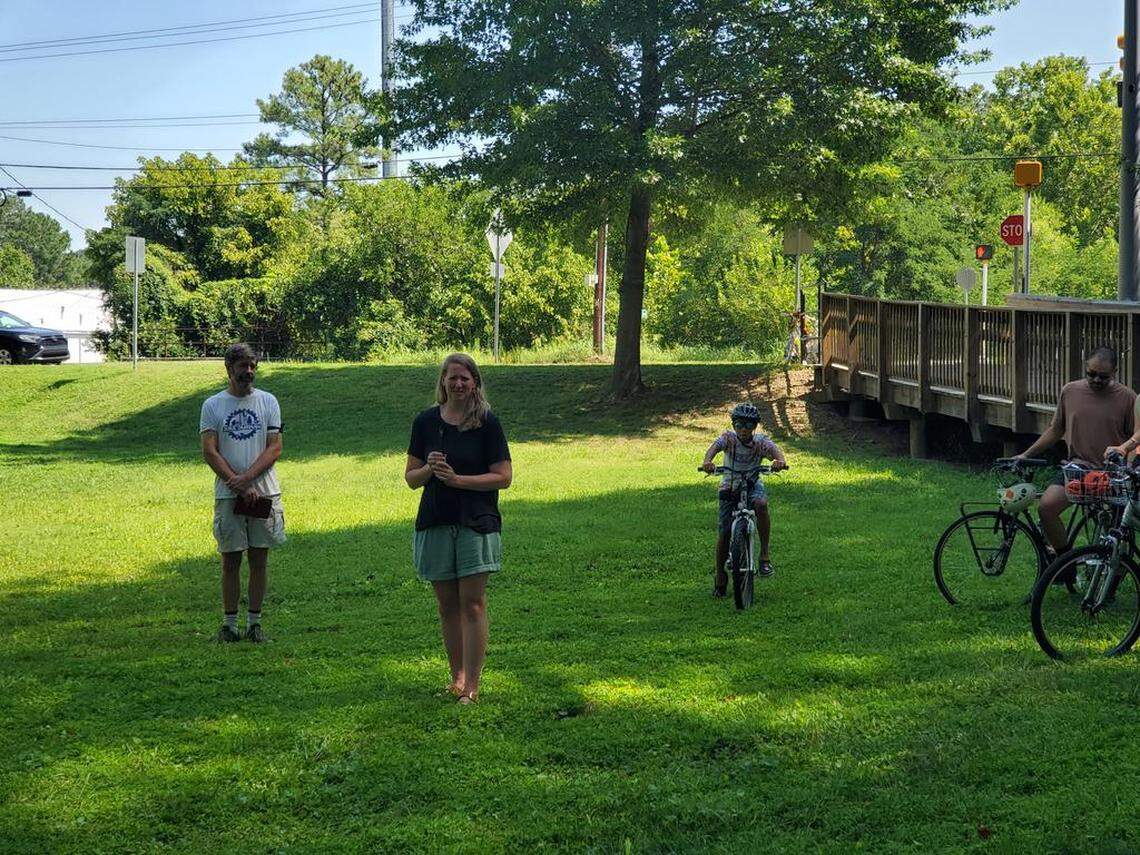 Allison Simpson, widow of Matt Simpson, speaks about her late husband at Westover Park in Durham, where bicyclists gathered for a Ride of Silence in memory of Mat Simpson, who was struck by a hit-and-run driver on July 10, 2022, while in the crosswalk on Guess Road, and died from his injuries.